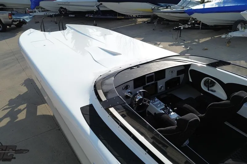 Slide: The Image of 2009 Nordic 36 Hurricane boat with sleek white design and modern cockpit. - 40