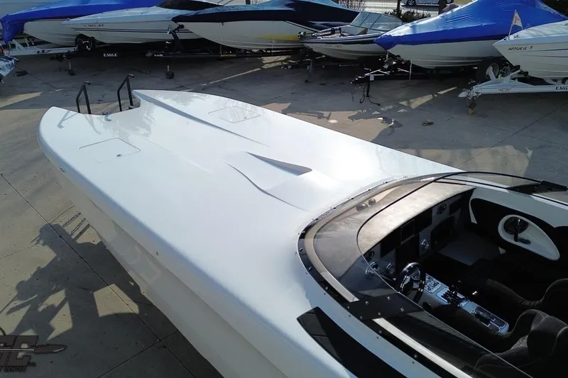 Slide: The Image of 2009 Nordic 36 Hurricane speedboat, sleek design, parked among other boats. - 41