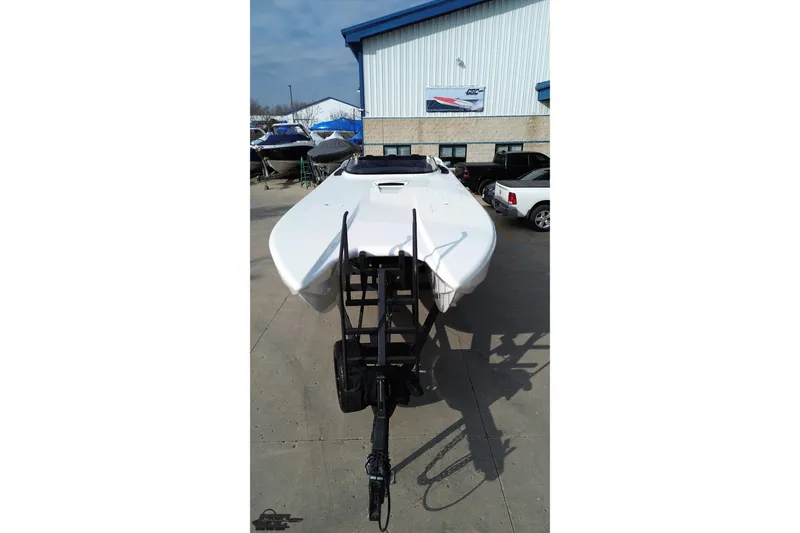 Slide: The Image of 2009 Nordic 36 Hurricane boat on trailer outside a warehouse. - 51