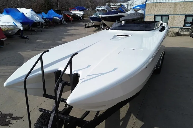 Slide: The Image of 2009 Nordic 36 Hurricane powerboat on trailer, surrounded by covered boats. - 52