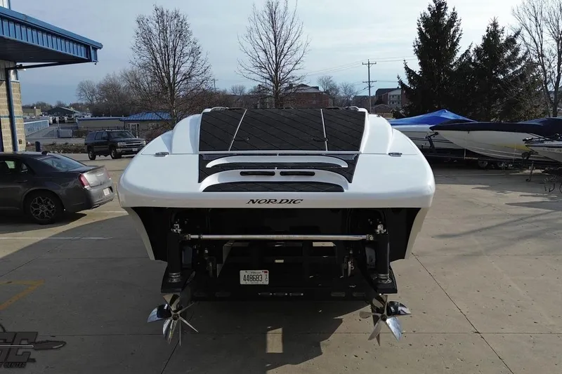 Slide: The Image of 2009 Nordic 36 Hurricane boat, rear view, parked outdoors with other vehicles. - 59