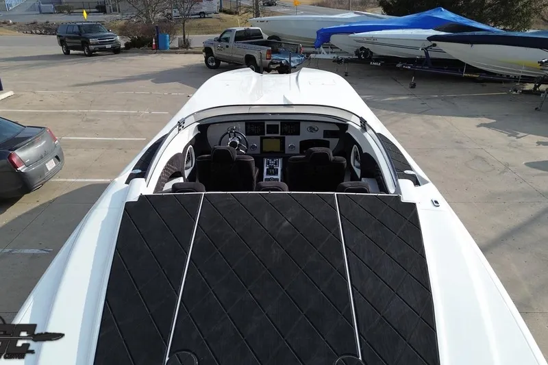 Slide: The Image of 2009 Nordic 36 Hurricane boat parked in a lot, showcasing sleek design and cockpit. - 65