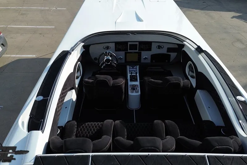 Slide: The Image of Interior view of 2009 Nordic 36 Hurricane boat, featuring sleek black seating and modern dashboard. - 66
