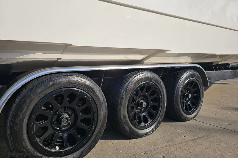 Slide: The Image of Triple-axle trailer with black wheels for 2009 Nordic 36 Hurricane boat. - 7