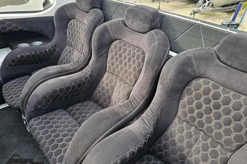 Slide: The Image of Luxurious seating in a 2009 Nordic 36 Hurricane boat with hexagonal pattern upholstery. - 72