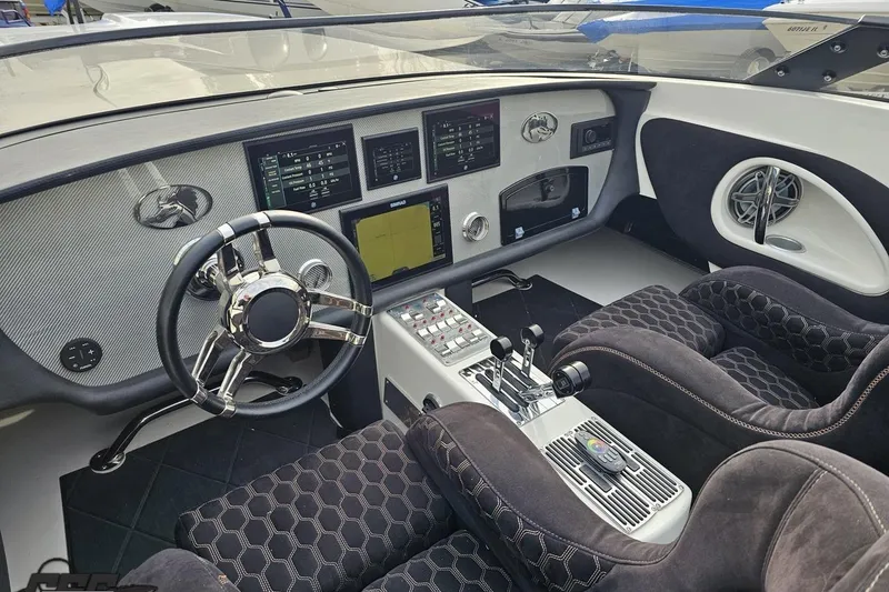 Slide: The Image of Cockpit of 2009 Nordic 36 Hurricane boat with modern controls and plush seating. - 77