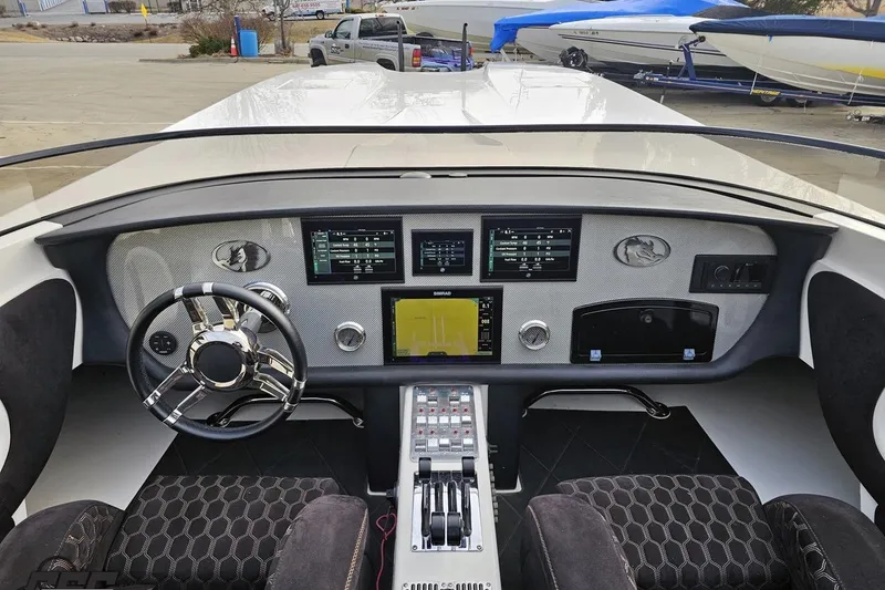 Slide: The Image of Interior dashboard of a 2009 Nordic 36 Hurricane boat with modern controls and steering wheel. - 78