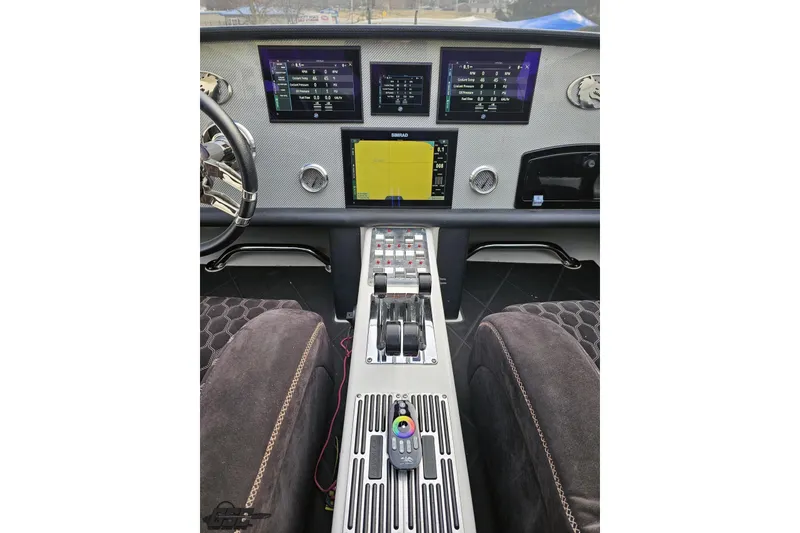 Slide: The Image of Dashboard of a 2009 Nordic 36 Hurricane boat with advanced navigation displays. - 80