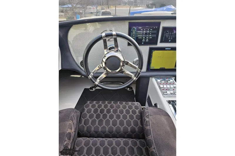 Slide: The Image of Steering wheel and dashboard of 2009 Nordic 36 Hurricane boat with modern controls. - 81