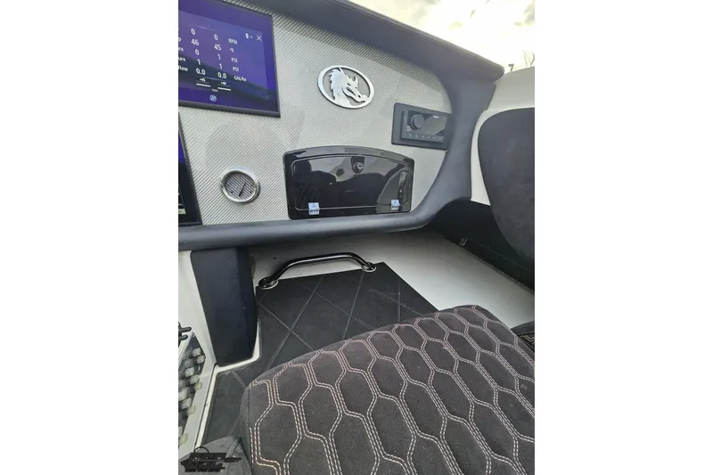 Slide: The Image of 2009 Nordic 36 Hurricane boat dashboard with digital display and textured upholstery. - 83