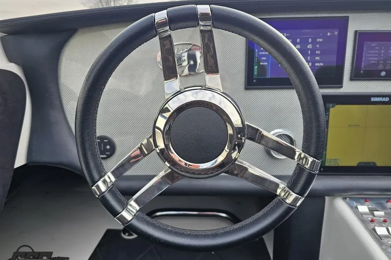 Slide: The Image of Steering wheel of a 2009 Nordic 36 Hurricane boat with modern dashboard displays. - 85