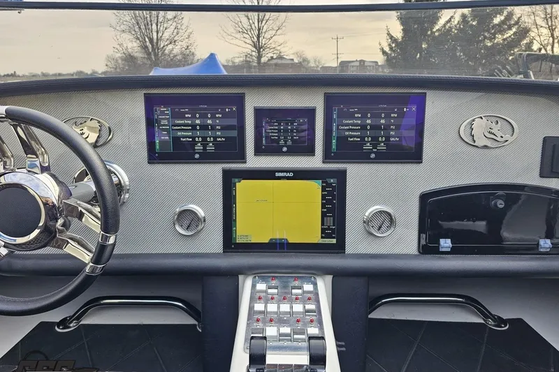 Slide: The Image of Dashboard of a 2009 Nordic 36 Hurricane boat with navigation screens and controls. - 86