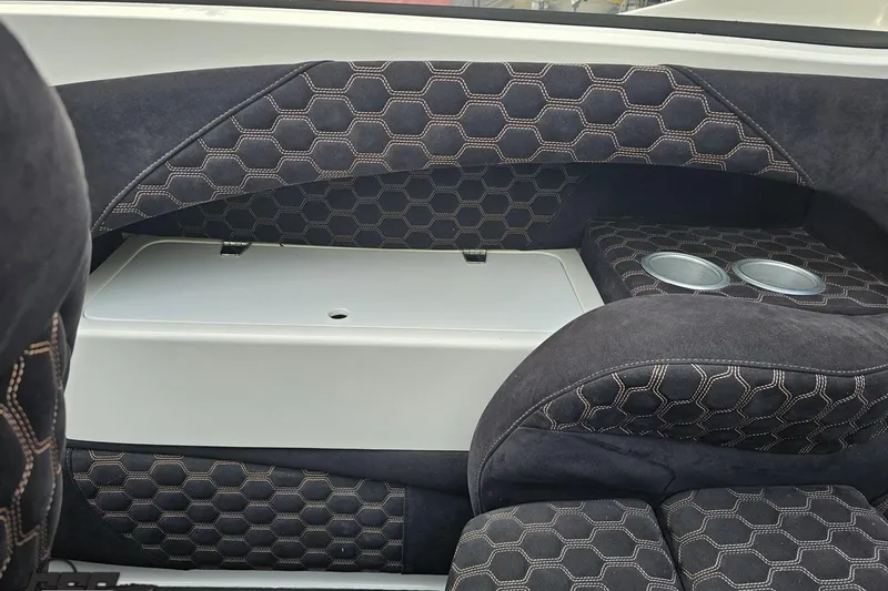 Slide: The Image of Interior of 2009 Nordic 36 Hurricane boat with hexagonal-patterned upholstery and cup holders. - 89