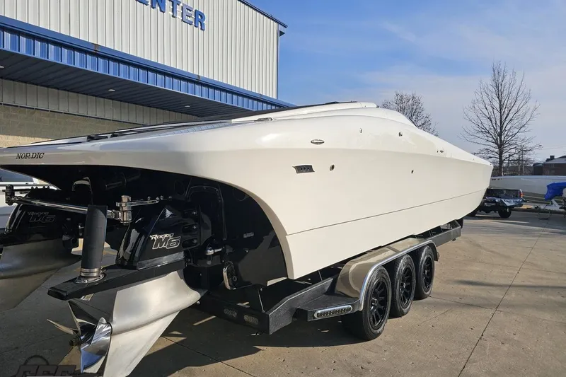 Slide: The Image of 2009 Nordic 36 Hurricane boat on trailer outside a building, showcasing sleek design. - 9