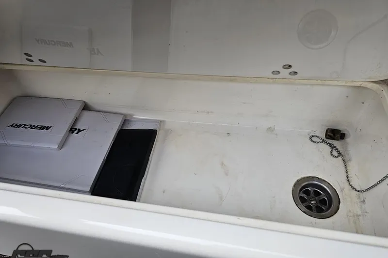 Slide: The Image of Storage compartment of a 2009 Nordic 36 Hurricane boat with Mercury manuals. - 90