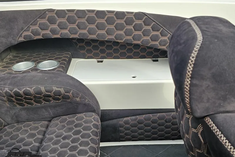 Slide: The Image of 2009 Nordic 36 Hurricane boat interior with hexagonal-patterned upholstery and cup holders. - 92