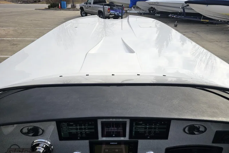 Slide: The Image of 2009 Nordic 36 Hurricane boat dashboard with sleek white exterior in a marina setting. - 95