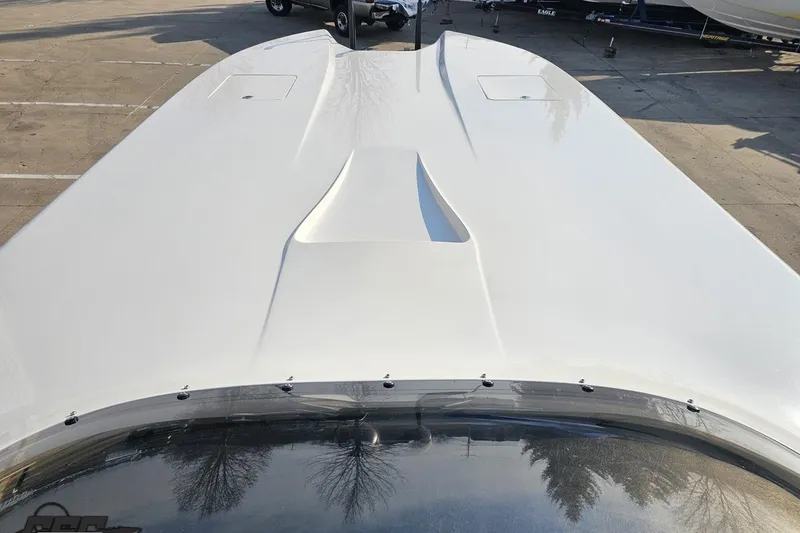 Slide: The Image of 2009 Nordic 36 Hurricane boat deck, sleek white design in a parking lot. - 96