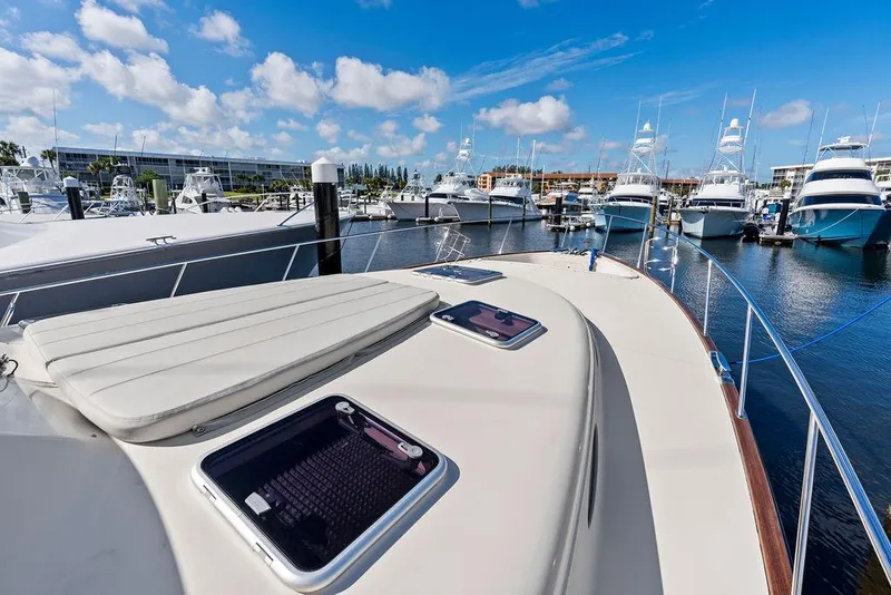 Slide: The Image of 2018 Palm Beach Motor Yachts PB55 Flybridge docked, showcasing sleek design and marina view. - 19