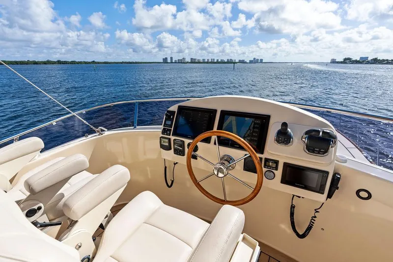 Slide: The Image of Flybridge helm of 2018 Palm Beach Motor Yachts PB55, overlooking serene ocean view. - 27