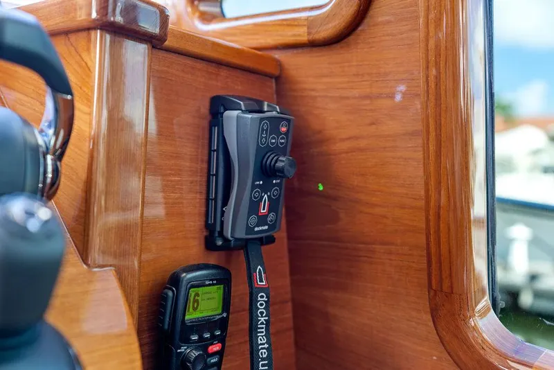 Slide: The Image of Control panel and radio on 2018 Palm Beach Motor Yachts PB55 Flybridge, wooden interior detail. - 39