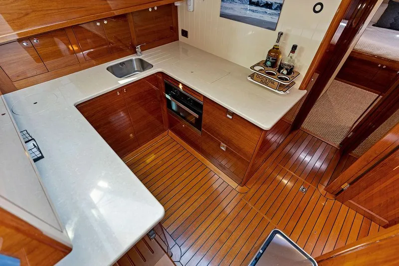 Slide: The Image of Luxurious 2018 Palm Beach PB55 Flybridge yacht kitchen with sleek wood finish and modern appliances. - 41