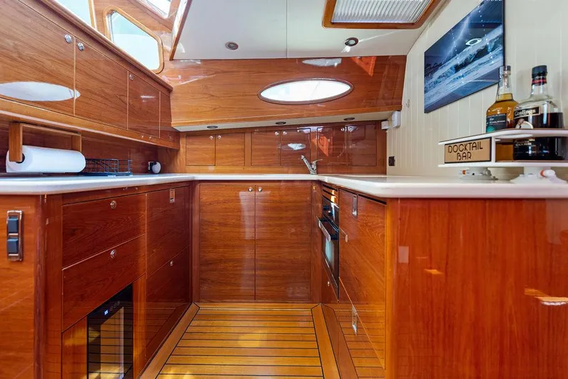 Slide: The Image of Luxurious wooden interior of 2018 Palm Beach Motor Yachts PB55 Flybridge kitchen area. - 42