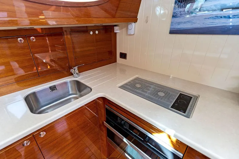 Slide: The Image of Luxurious kitchen area in 2018 Palm Beach Motor Yachts PB55 Flybridge with sleek wood cabinetry. - 43