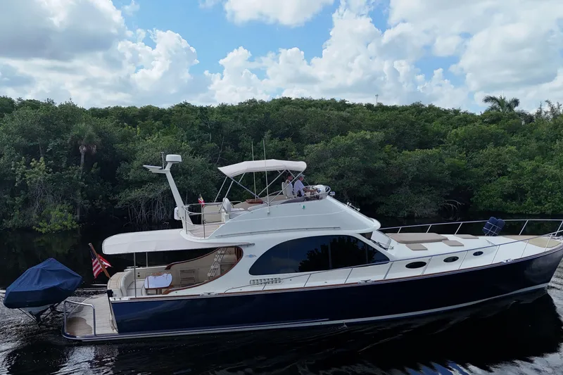 Slide: The Image of 2018 Palm Beach Motor Yachts PB55 Flybridge cruising on a serene waterway. - 6
