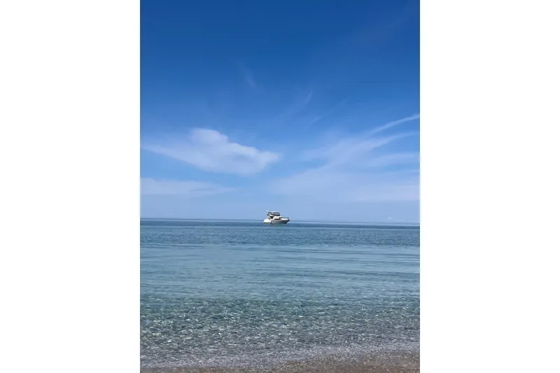 Slide: The Image of A 2001 Regal Commodore 3780 yacht on calm blue sea under clear sky. - 12