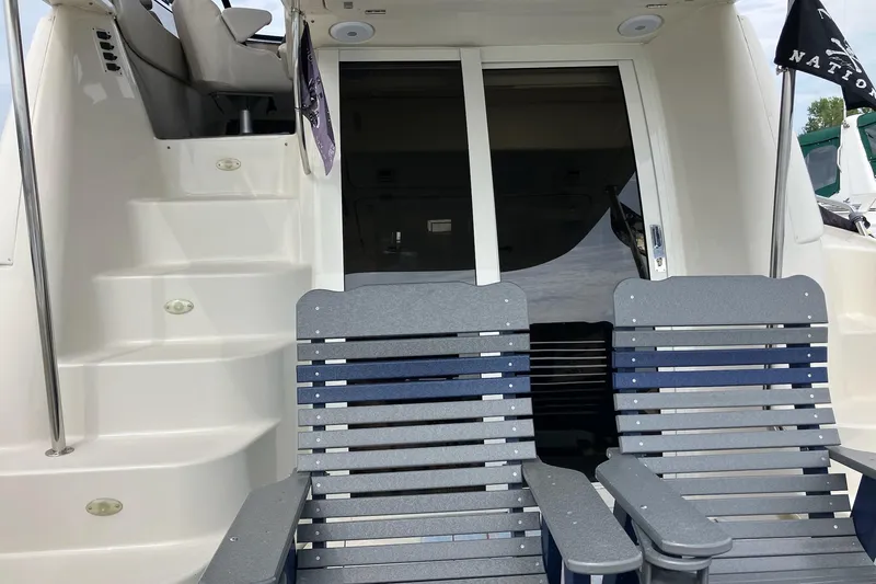 Slide: The Image of 2001 Regal Commodore 3780 yacht with deck chairs and cabin entrance. - 14