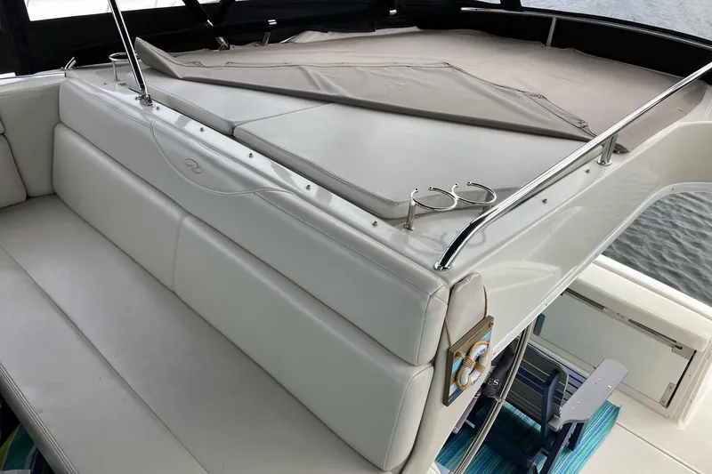 Slide: The Image of 2001 Regal Commodore 3780 yacht interior with white seating and deck view. - 16