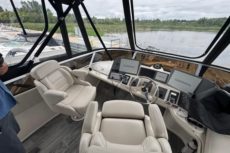 Slide: The Image of Cockpit of 2001 Regal Commodore 3780 with Garmin navigation systems and plush seating. - 17