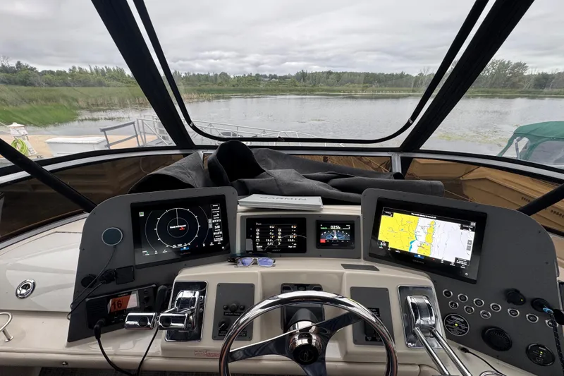 Slide: The Image of Cockpit view of a 2001 Regal Commodore 3780 boat with navigation screens and controls. - 20
