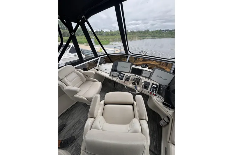 Slide: The Image of Interior view of 2001 Regal Commodore 3780 yacht cockpit with Garmin navigation systems. - 23