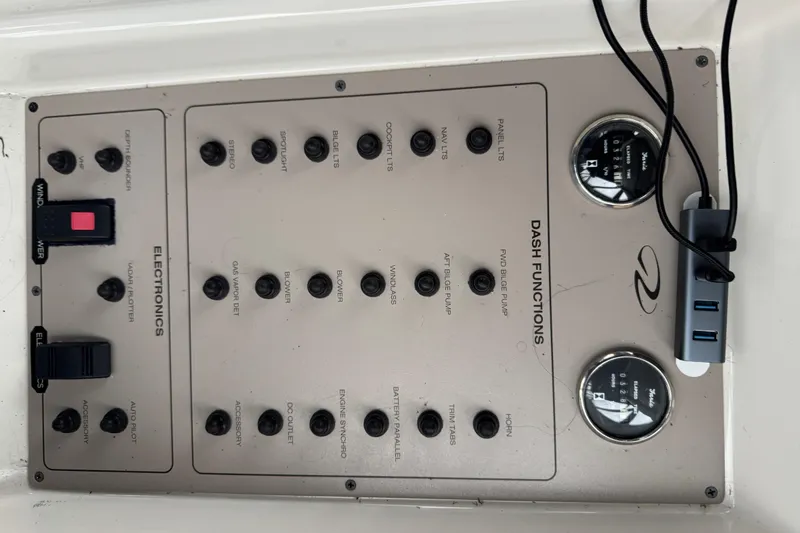 Slide: The Image of Control panel of a 2001 Regal Commodore 3780 boat with various switches and gauges. - 26