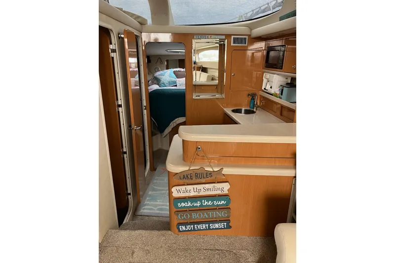 Slide: The Image of Interior of 2001 Regal Commodore 3780 yacht with cozy cabin and kitchenette. - 27