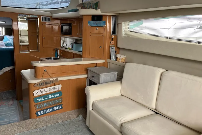 Slide: The Image of Interior of 2001 Regal Commodore 3780 yacht with cozy seating and kitchenette. - 29