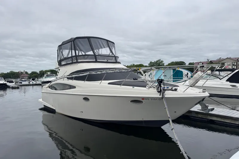 Slide: The Image of 2001 Regal Commodore 3780 yacht docked at marina under cloudy sky. - 3