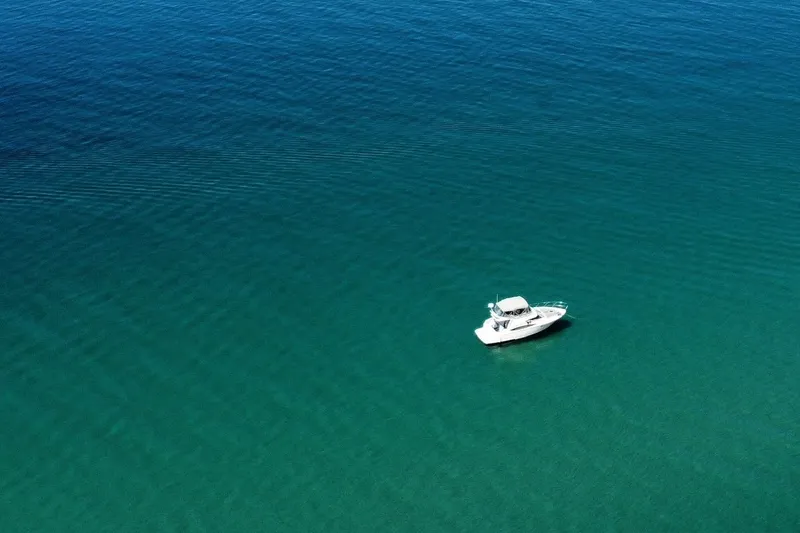 Slide: The Image of Aerial view of 2001 Regal Commodore 3780 yacht on calm blue water. - 4
