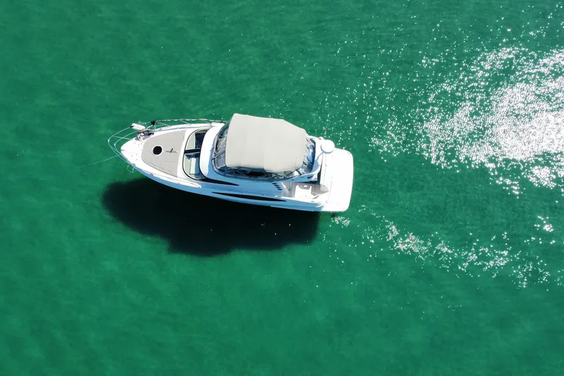 Slide: The Image of Aerial view of 2001 Regal Commodore 3780 yacht on clear turquoise water. - 5