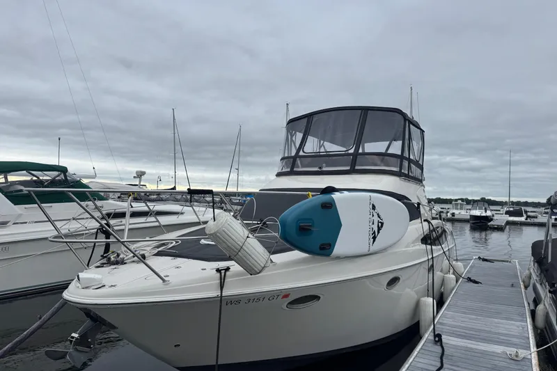 Slide: The Image of 2001 Regal Commodore 3780 yacht docked with paddleboard on deck. - 7