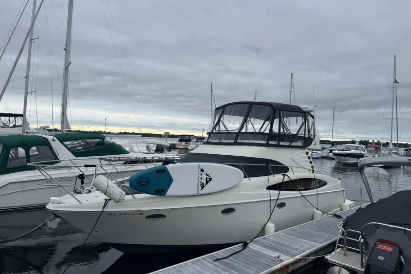 Slide: The Image of 2001 Regal Commodore 3780 yacht docked at marina with paddleboard on deck. - 8