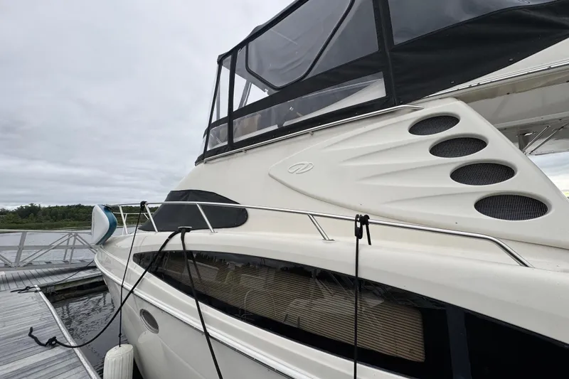 Slide: The Image of 2001 Regal Commodore 3780 yacht docked, featuring sleek design and modern amenities. - 9