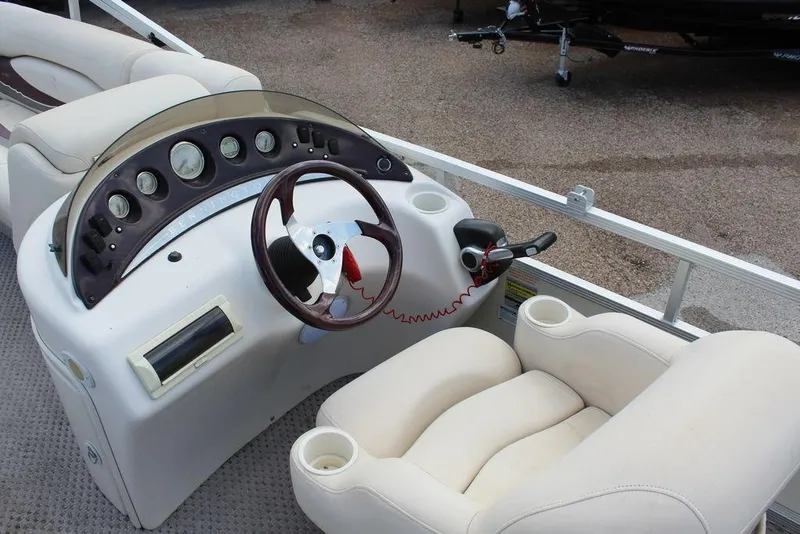 Slide: The Image of 2005 Bennington 2275 RL boat dashboard with steering wheel and gauges. - 12