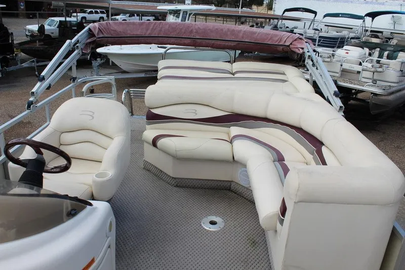 Slide: The Image of 2005 Bennington 2275 RL pontoon boat with plush seating and steering wheel. - 13