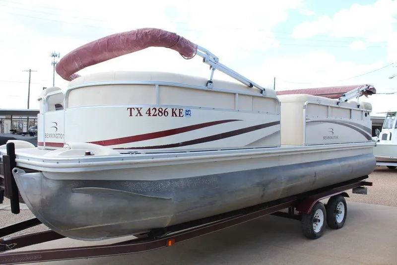 Slide: The Image of 2005 Bennington 2275 RL pontoon boat on trailer, side view with maroon canopy. - 3