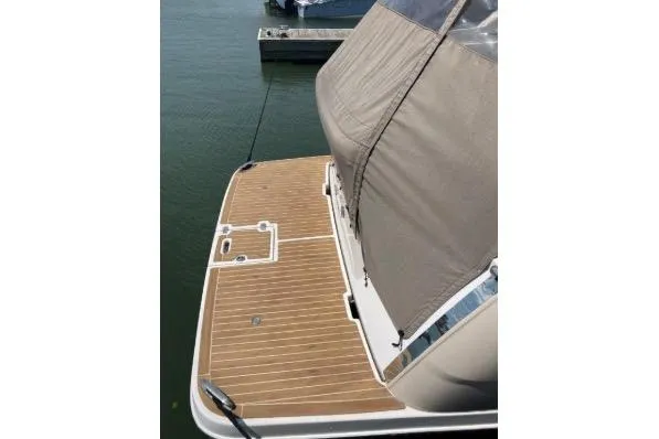 Slide: The Image of 2013 Regal 30 Express boat with teak swim platform, docked on calm water. - 12