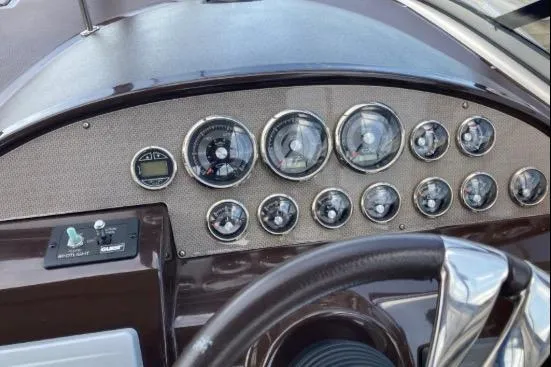 Slide: The Image of Dashboard of a 2013 Regal 30 Express boat with multiple gauges and controls. - 14