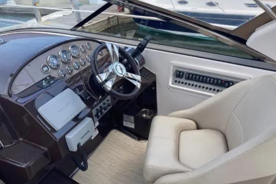 Slide: The Image of Cockpit of 2013 Regal 30 Express boat with steering wheel and control panel. - 19